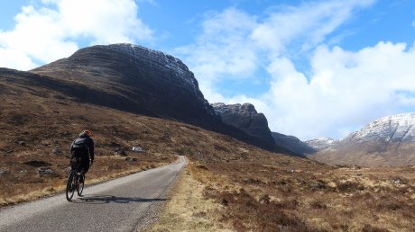 Cyclist on the North Coast 500 at the Bealach Na Ba road to Applecross
